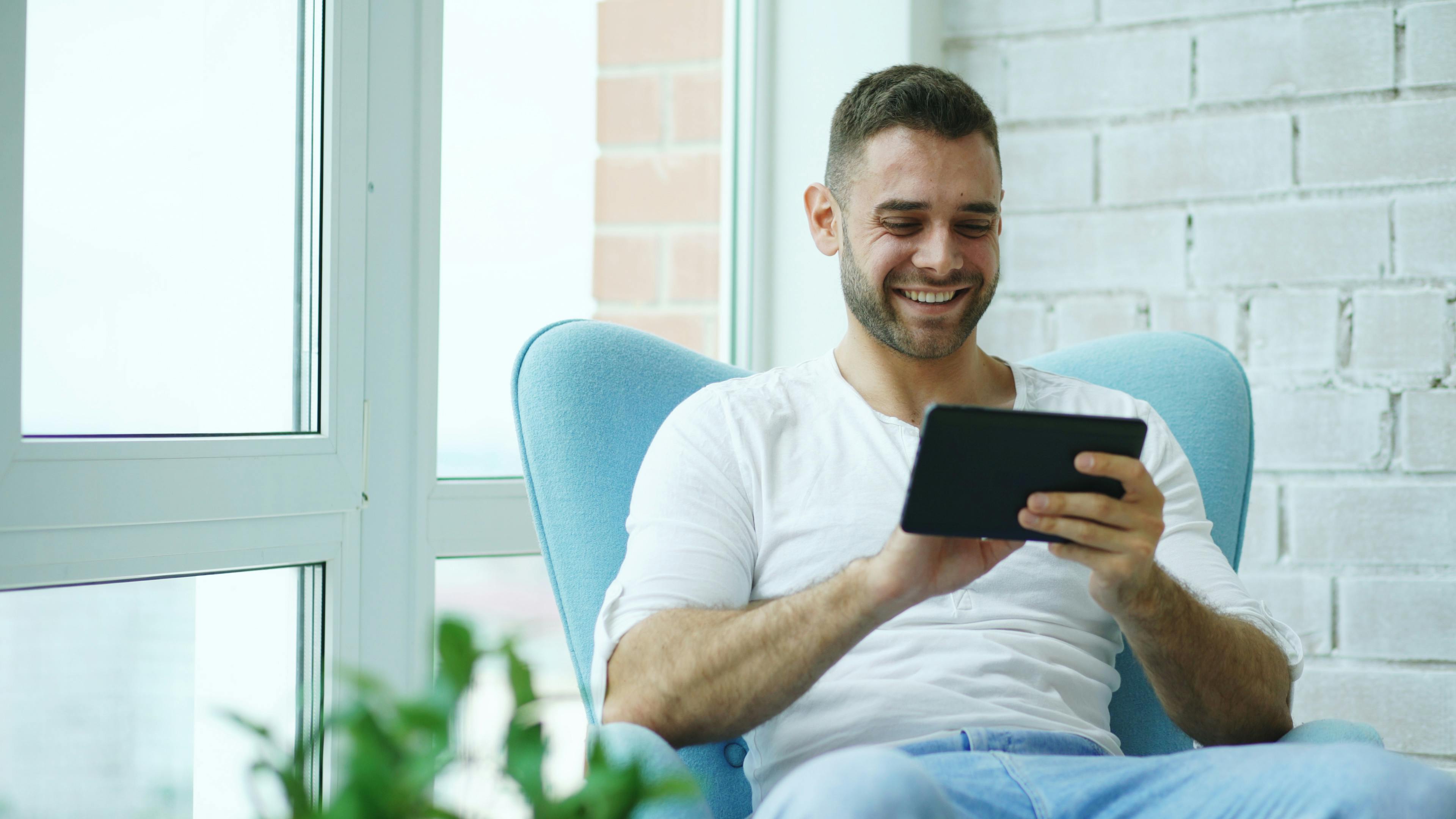 Happy homeowner using tablet with strong Wi-Fi